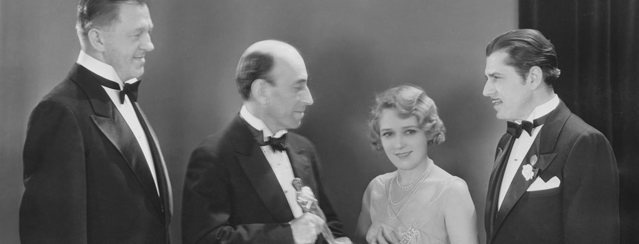 Hans Kraly, William C. de Mille, Mary Pickford, and Warner Baxter